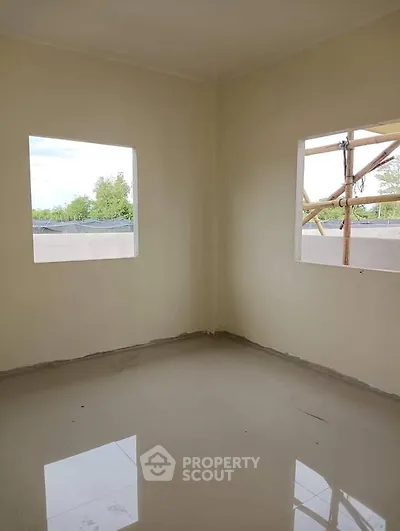 Spacious unfinished room with large windows and tiled floor, perfect for customization.
