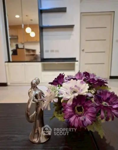 Stylish interior with elegant decor and vibrant flowers, showcasing modern living space.