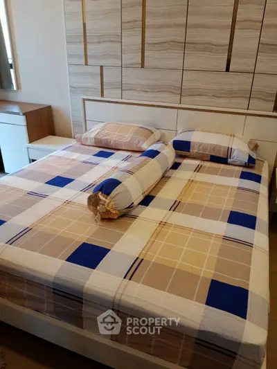 Cozy bedroom with modern design and stylish bedding in a contemporary apartment.
