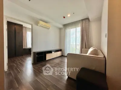 Spacious living room with modern decor and large windows for natural light.