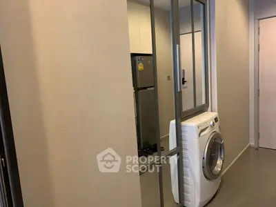 Modern apartment hallway with washing machine and mirrored closet