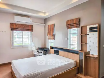 Spacious bedroom with modern furniture and natural light, perfect for a comfortable living experience.