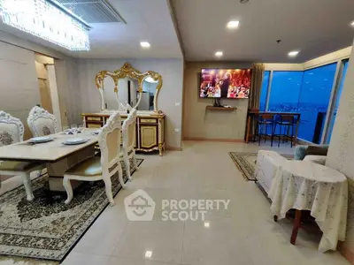 Luxurious dining and living area with elegant furniture and stunning city view.