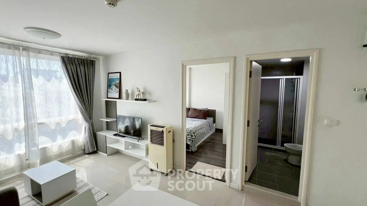 Modern apartment interior with living room and bedroom, featuring natural light and stylish decor.