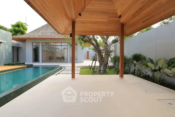 Luxurious modern villa with pool and lush garden, perfect for serene living.