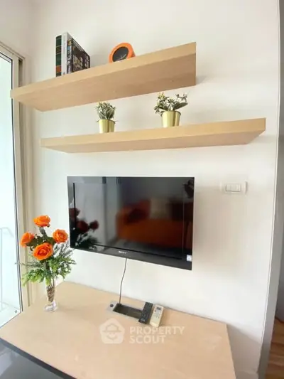 Modern living room with wall-mounted TV and stylish floating shelves