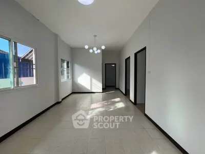Spacious and bright interior with modern lighting and large windows, perfect for customization.