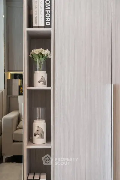 Stylish modern living room with elegant shelving and decorative accents.