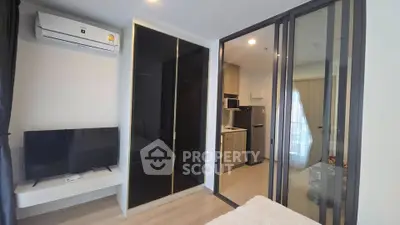 Modern studio apartment with sleek design and compact kitchen