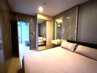 Luxurious bedroom with marble walls and mirrored closet in modern apartment
