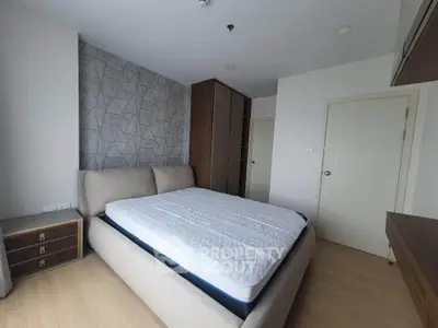 Spacious bedroom with modern decor and ample natural light, featuring a comfortable bed and stylish wardrobe.