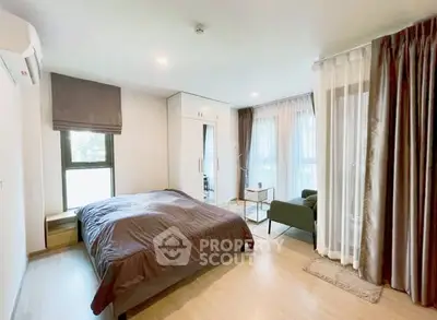 Spacious modern bedroom with large windows and elegant decor