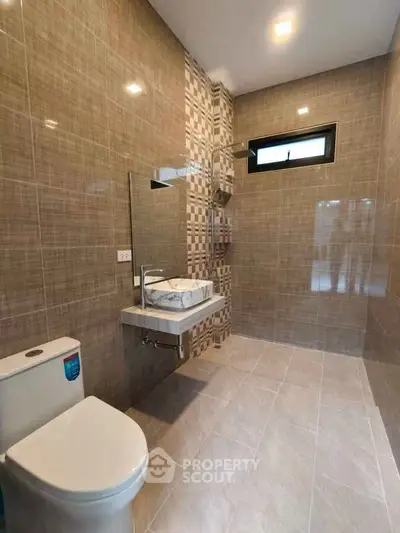 Modern bathroom with sleek tiles and contemporary fixtures