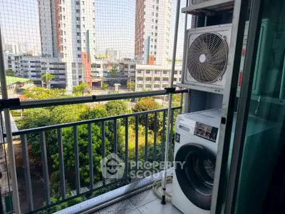 Charming balcony with city view and laundry setup in modern apartment