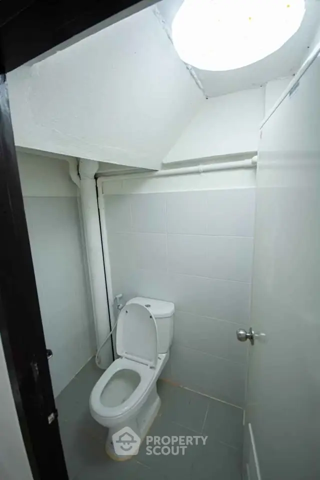Compact bathroom with modern toilet and minimalist design