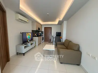 Modern living room with sleek furniture and open kitchen layout in a stylish apartment.