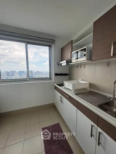 Modern kitchen with stunning city view, featuring sleek cabinetry and ample natural light.