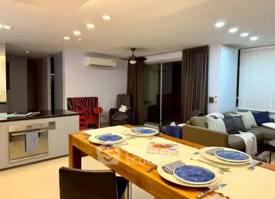 Modern open-plan living and dining area with stylish decor and ample lighting.
