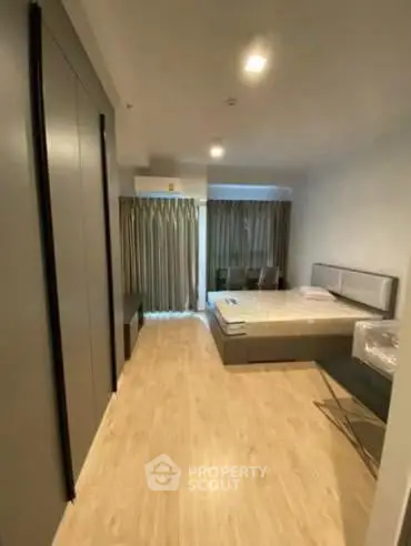 Spacious modern bedroom with large window and elegant decor