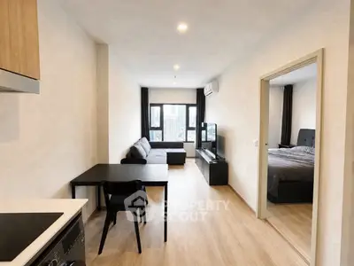 Modern open-plan living room with sleek furniture and natural light in a contemporary apartment.