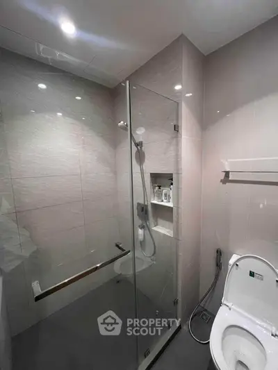 Modern bathroom with glass shower enclosure and sleek fixtures