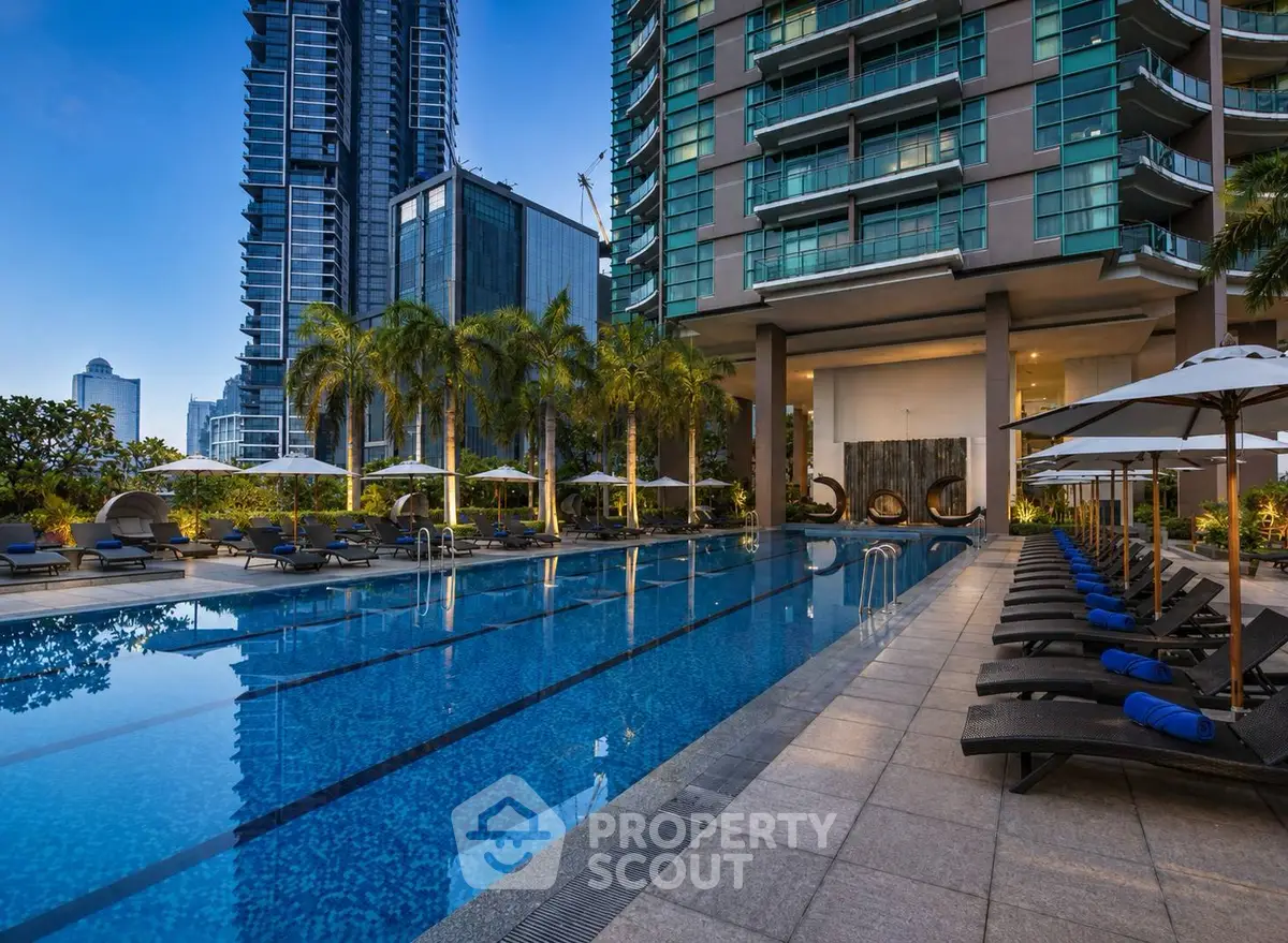 Luxurious high-rise apartment with stunning pool and palm trees, perfect for urban living.