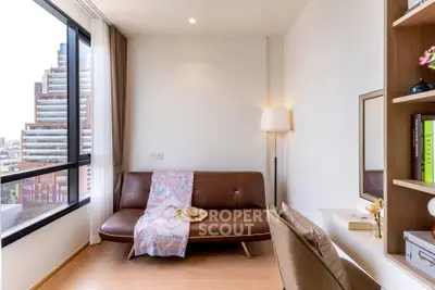 Modern living room with city view, stylish sofa, and elegant decor in a high-rise apartment.