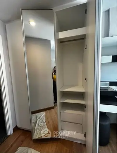 Modern wardrobe with mirror door in stylish bedroom interior