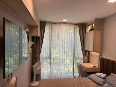 Modern bedroom with large window, stylish decor, and natural light