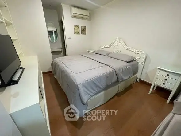 Cozy bedroom with elegant bed frame and modern decor in a stylish apartment.