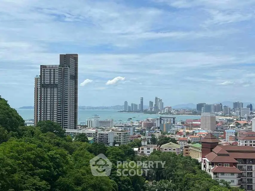Stunning cityscape view with high-rise buildings and ocean backdrop.