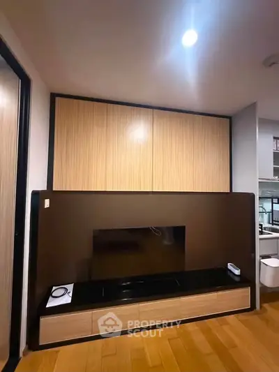 Modern living room with sleek wooden cabinetry and built-in entertainment center.