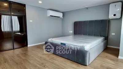 Spacious modern bedroom with sleek design and large bed in a stylish apartment.