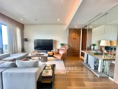 Luxurious modern living room with stylish decor and large TV, perfect for relaxation.