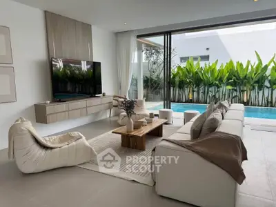 Luxurious living room with pool view, modern furniture, and elegant decor in a contemporary home.