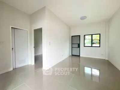 Spacious modern living room with glossy tiled floors and large window