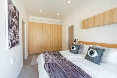 Spacious modern bedroom with stylish decor and ample storage space