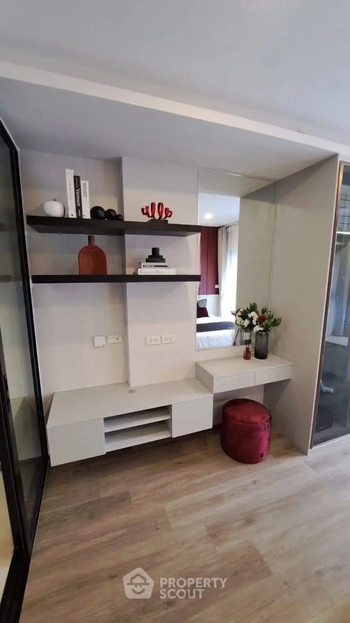 Modern living room with stylish shelving and elegant decor in a contemporary apartment.