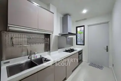Modern kitchen with sleek cabinetry and gas stove in a contemporary home.