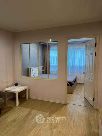 Cozy apartment interior with wooden flooring and bedroom view
