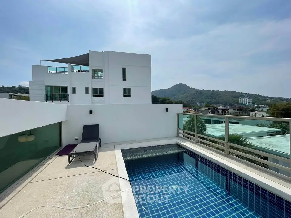 Luxurious rooftop pool with stunning mountain views in modern residential building.