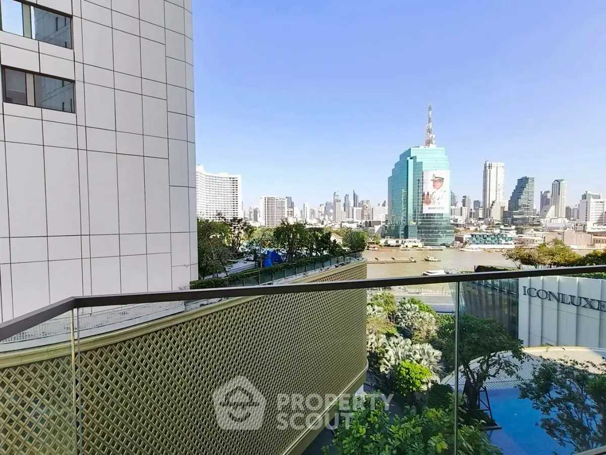 Stunning cityscape view from a modern balcony with glass railing and lush greenery.