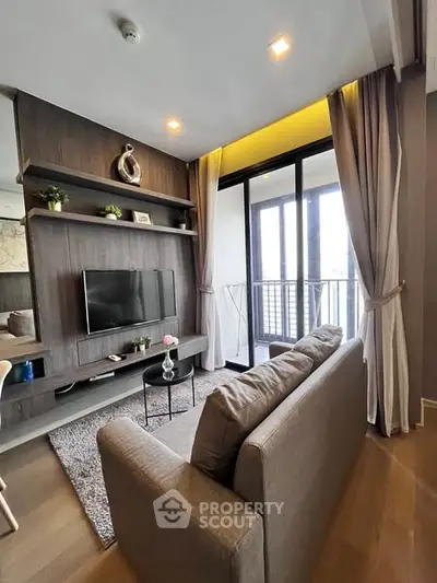 Modern living room with balcony, stylish decor, and cozy seating area.