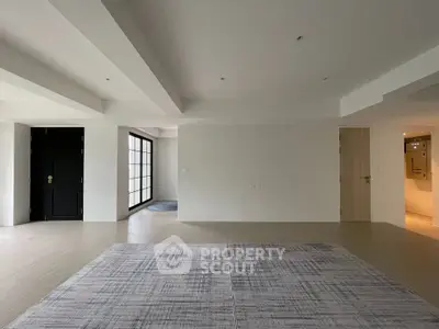 Spacious modern living room with minimalist design and large windows