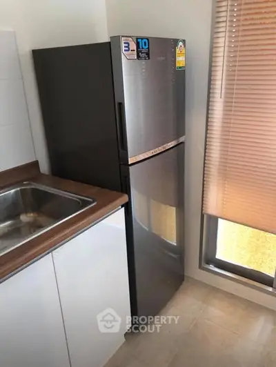 Modern kitchen with sleek stainless steel fridge and stylish cabinetry