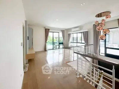 Spacious modern living room with elegant lighting and large windows for natural light.