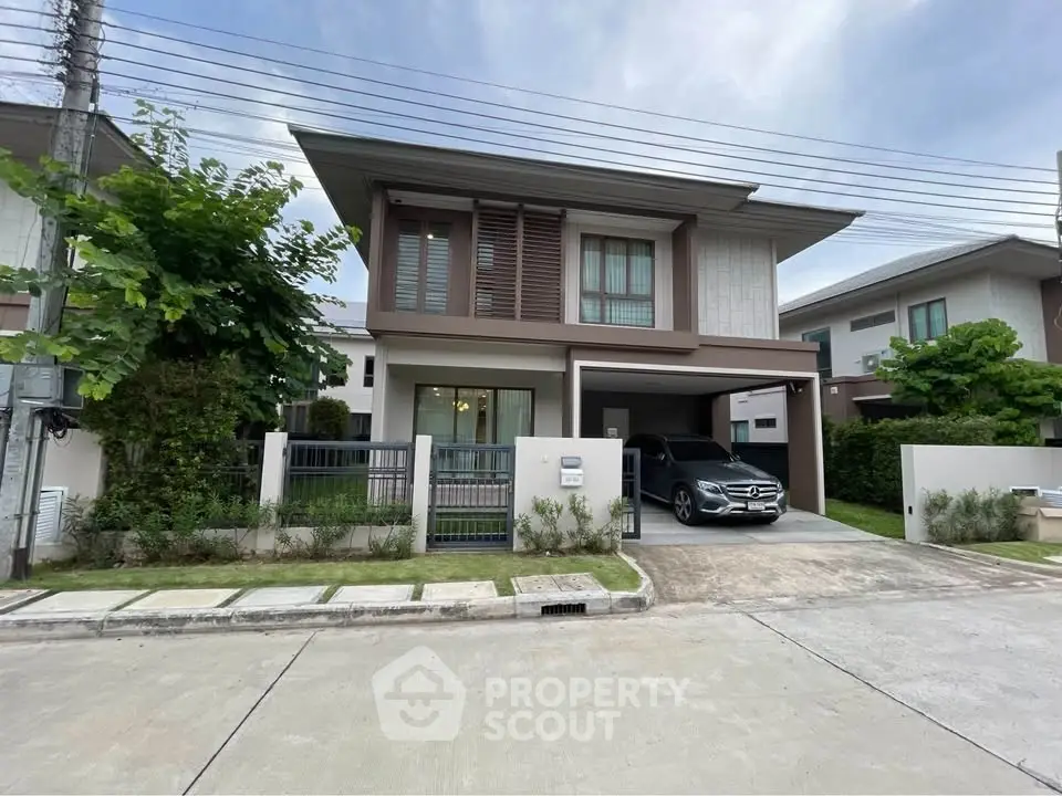Modern two-story house with carport and landscaped front yard in a suburban neighborhood.