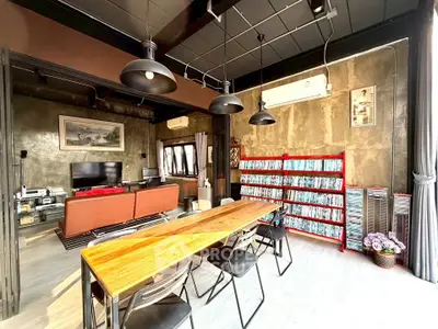 Stylish industrial-style living room with modern decor and ample natural light.