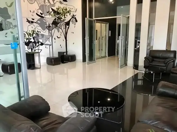 Luxurious modern lobby with sleek leather seating and artistic wall design.