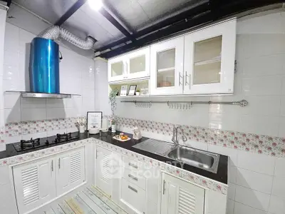 Charming kitchen with floral backsplash and modern appliances in cozy home.